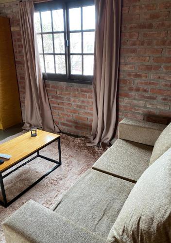 a living room with a couch and a coffee table at Cabañas Abigail in Nono