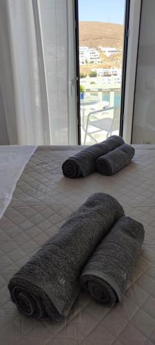 three towels laying on a bed in a room at Isavella's House in Pera Gyalos