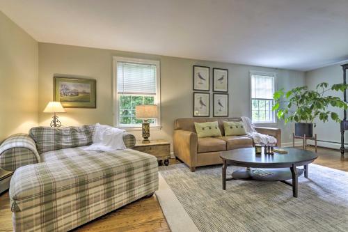 a living room with a couch and a table at Historic Essex Home with Large Yard Near Downtown! in Essex