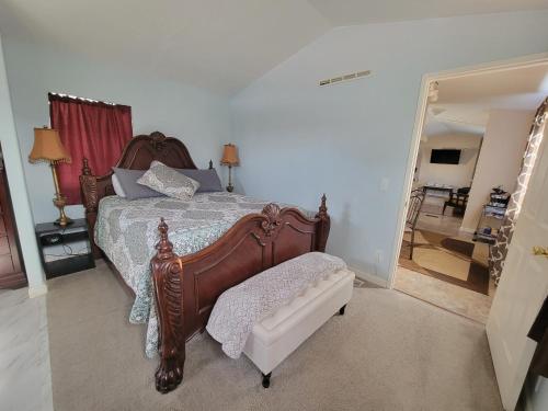 a bedroom with a wooden bed and a mirror at Hidden Gem 2 bed 2 bath private mobile home with great parking in Fernley