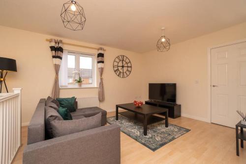 a living room with a couch and a television at Bristol's Coach House - 2 Bedroom Detached Apartment with Secure Parking in Bristol