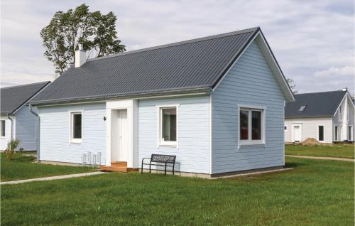 a white house with a black roof at Sea You in Olpenitz