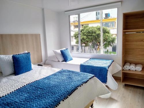 Postel nebo postele na pokoji v ubytování Hotel Federman Park Bogota