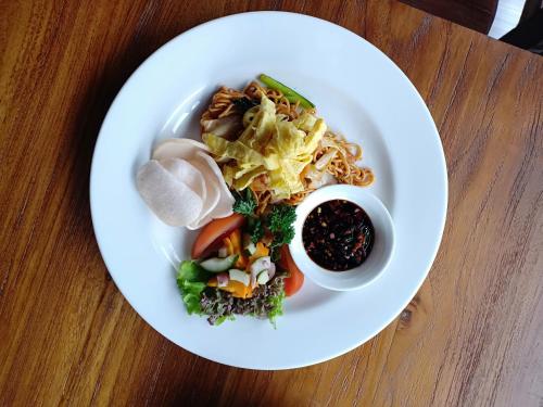 a white plate of food on a table at D Home Seminyak in Seminyak