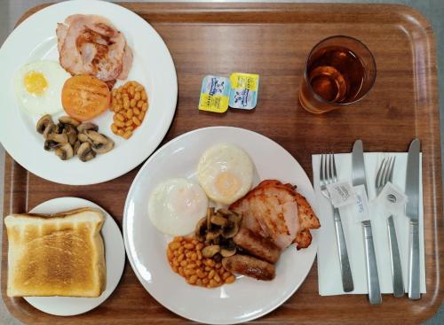 a tray with two plates of breakfast food on it at Country Ayr Motel in Ayr