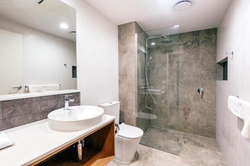 a bathroom with a sink and a shower at Quality Hotel City Centre in Coffs Harbour
