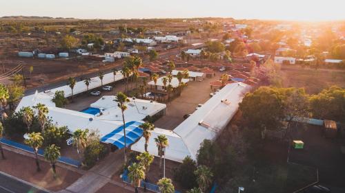 an overhead view of a building with palm trees at Bluestone Motor Inn in Tennant Creek