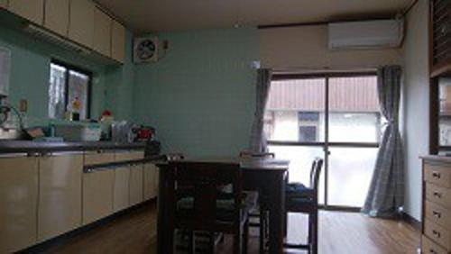 a kitchen with a counter and a window and a table at Minshuku Marin - Vacation STAY 90965 in Higashikagawa