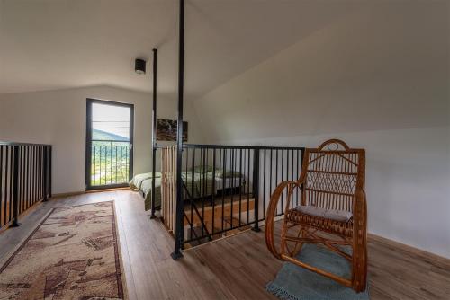 a bedroom with a bed and a chair in it at Widokówka Myczkowce in Myczkowce