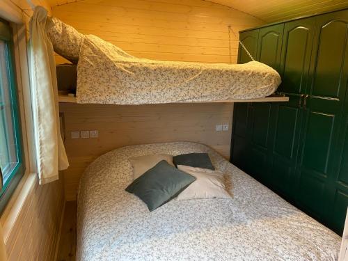 a bedroom with two bunk beds in a house at La roulotte de bonneval in Charleval