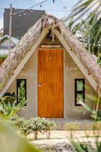 a small house with a brown door at Your Brothers House Tribal Village in Legazpi