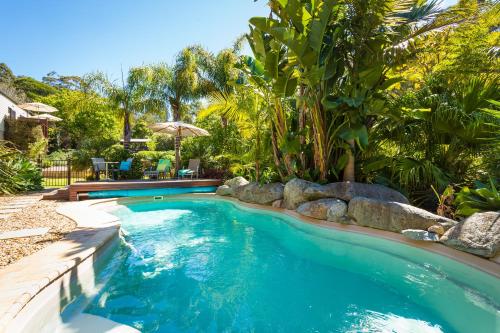 a swimming pool in a yard with trees and plants at Balconies Dolphincove in Tura Beach