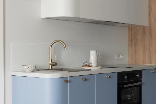 a kitchen with a sink and a counter top at Flatbook - City Center Apartments Dwie Motławy in Gdańsk