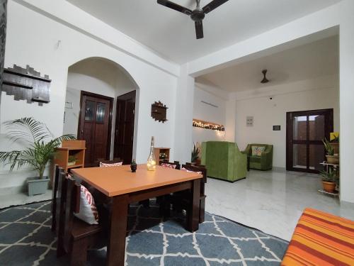 a living room with a wooden table and chairs at Jubels Homestay in Guwahati