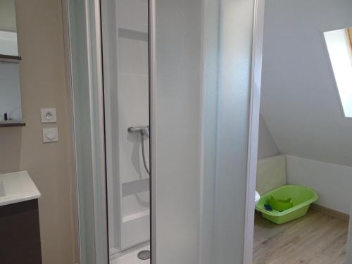 a bathroom with a shower with a glass door at Charming, fully renovated stone house in Bricqueville-sur-Mer