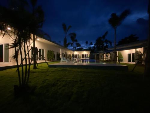 a villa with a swimming pool at night at Le Petit Saint Tropez in Khanom