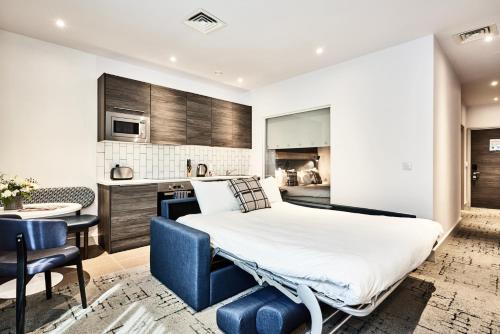a bedroom with a bed and a kitchen at Citadines City Centre Liverpool in Liverpool