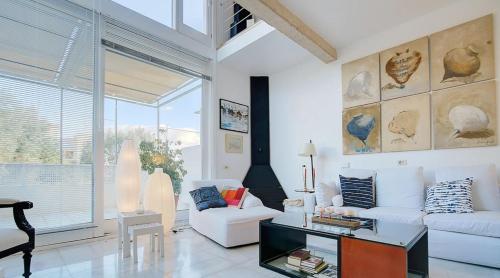 a living room with white furniture and a large window at Villa Bonanova Style in Palma de Mallorca