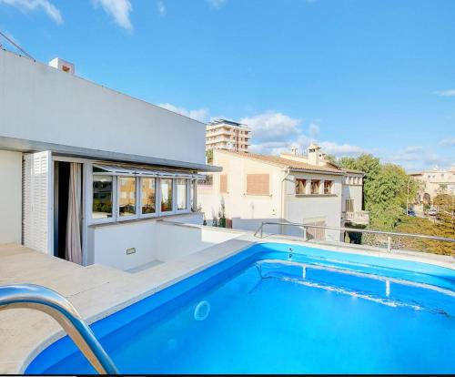 a swimming pool in the backyard of a house at Villa Bonanova Style in Palma de Mallorca