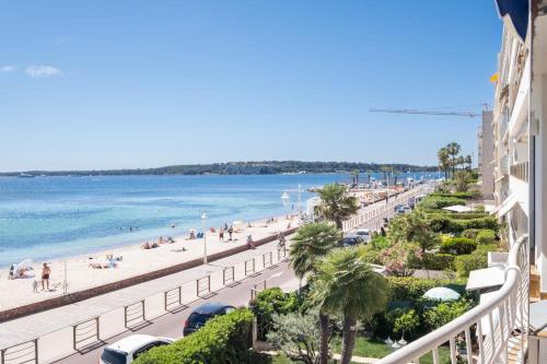 une vue sur la plage depuis le balcon d'un immeuble dans l'établissement SERRENDY  RARE !  Superbe appartement avec vue sur la mer , à Cannes