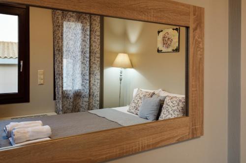 a bedroom with a large mirror on the wall at Seaside Getaway - Aelia Villa's Dreamy Paradise in Petalidhion