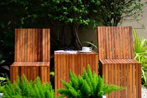 two wooden containers with a coffee cup on top at Grand BS Airport Hotel Suvarnabhumi in Lat Krabang