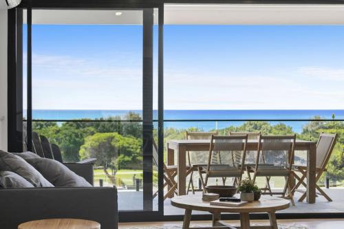 a living room with a table and chairs at Joy Apartment 1 in Lorne