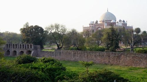 a building behind a stone wall in front of a building at B Nineteen in New Delhi