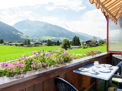 a table with a view of a field and mountains at Apartment near the ski area in Stuhlfelden in Stuhlfelden