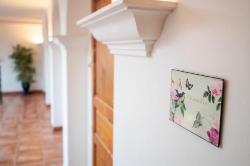 a picture of flowers on a wall in a hallway at LA VILLA BOLERO in Saint-Cyr-sur-Loire