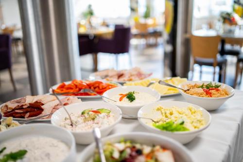 a table with many bowls of food on it at Słoneczne Wzgórze in Tarnów