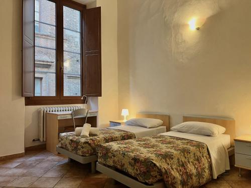 Postel nebo postele na pokoji v ubytování HostelCiompi