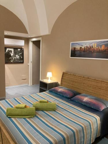 a bedroom with a large bed with two towels on it at Residenza delle Palme in Pantelleria
