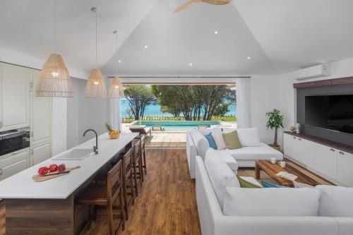 a kitchen and living room with a couch and a table at Luxury Glamping Beach Villas Porto Bus in Bale