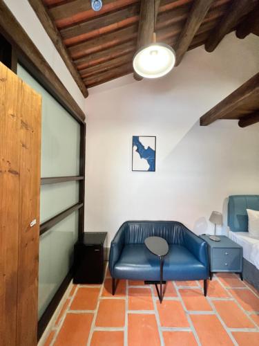 a living room with a blue couch and a table at 金門 日玥居 古厝民宿 Sunmoon19 B&B in Jinning
