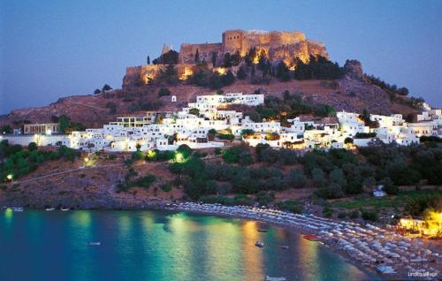 a town with a castle on top of a hill at OSSIANO POOL VILLAS, Heating Pool, 2 min drive to Haraki Beach & 10 to Lindos in Haraki
