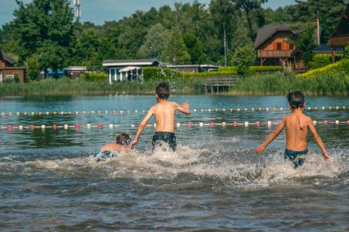 three young boys are playing in the water at EuroParcs Brunssummerheide in Brunssum