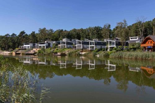 a row of houses next to a body of water at EuroParcs Brunssummerheide in Brunssum