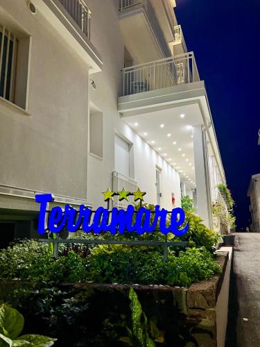 a sign for a hotel in front of a building at Hotel Terramare in Lido di Jesolo
