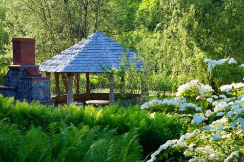a gazebo in the middle of a garden at Jaunkrastmaļi in Kandava
