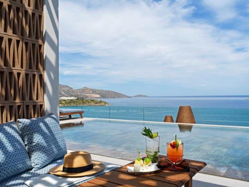 a view of the ocean from a villa with a pool at NIKO Seaside Resort MGallery in Agios Nikolaos