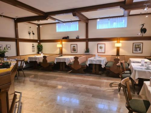 a room with tables and chairs in a restaurant at Pension Sonnenhof in Mörbisch am See