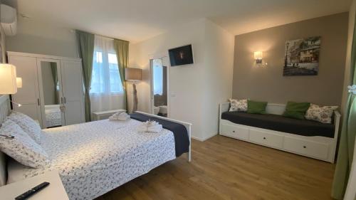 a small bedroom with a bed and a couch at Nature Home Apartment in Sandra