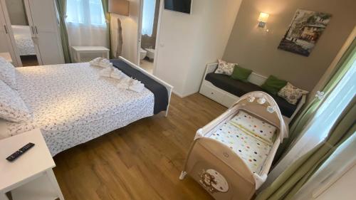 małą sypialnię z łóżkiem i łóżeczkiem dziecięcym w obiekcie Nature Home Apartment w mieście Sandra