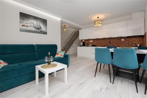 a living room with a couch and a table at Apartamenty Wczasowa by Renters in Międzywodzie