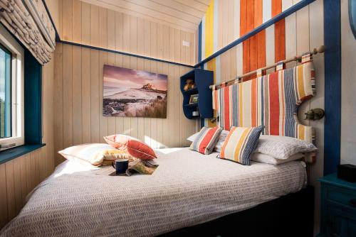 A bed or beds in a room at Berrington Beach Hut