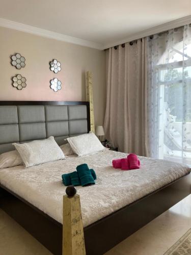 1 dormitorio con 1 cama con 2 almohadas en Aloha Gardens Townhouse, en Marbella