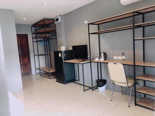 a room with a desk with a computer and a chair at Laemdin Hotel in Koh Samui 