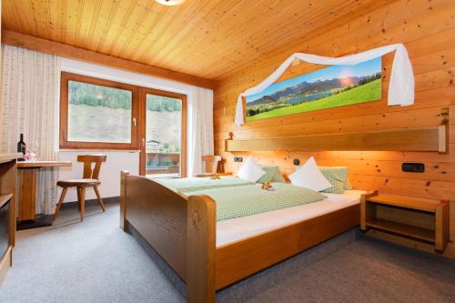 a bedroom with a bed in a wooden room at Mittermooshof in Walchsee