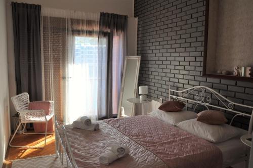 a bedroom with a bed and a brick wall at Romantic Boxavia in Božava